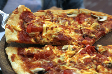 Slices of pizza on a wooden tray 