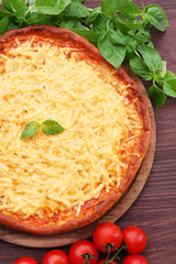 Cheese pizza with cherry tomatoes on table close up