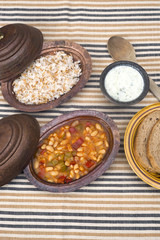 Turkish traditional meal, beans, rice, mixed pickles and tzatziki