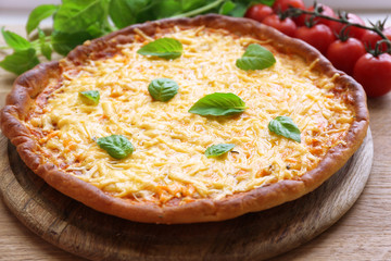 Cheese pizza with cherry tomatoes on table close up