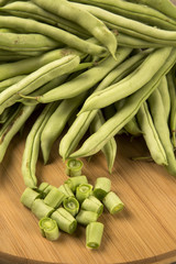 small and slender green beans (haricot vert) on a wood