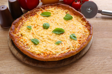 Cheese pizza with vegetables on table close up