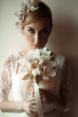 beautiful gorgeous stylish bride with orchids getting prepared in the morning in the room