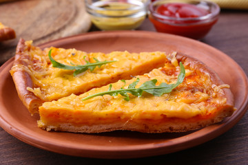 Slices of tasty cheese pizza with arugula and vegetables on table close up