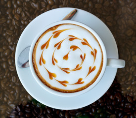 Hot coffee with heart pattern in white cup