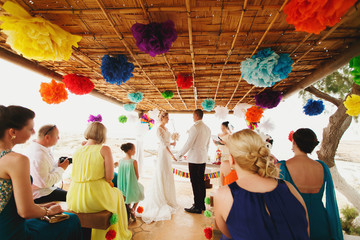 beautiful  gorgeous blonde bride with orchids and stylish groom, hawai colorful ceremony  on cyprus