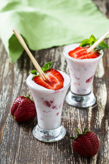 Frozen fruit smoothies with fresh strawberries on top