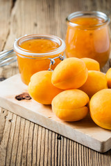 Fresh apricots and homemade apricot chutney  in a glass jar