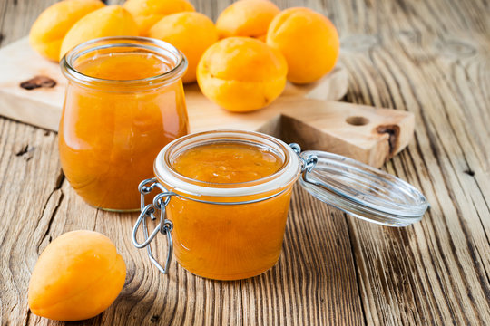 Homemade organic apricot jam in glass jar and ripe apricots