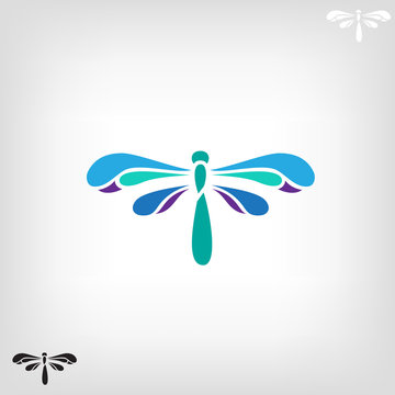 Dragonfly silhouette on light background.