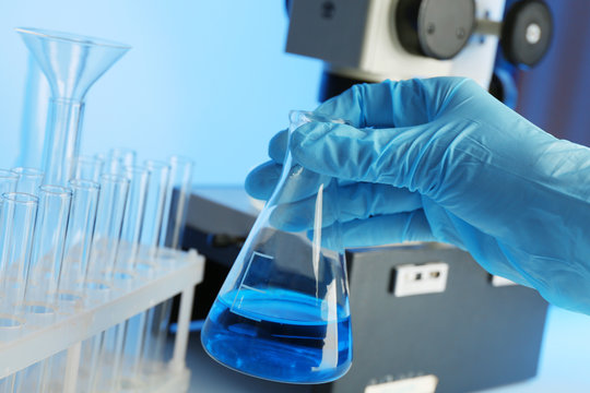 Test tube in scientist hand in laboratory