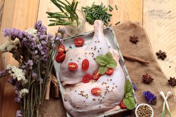 Fresh chicken and tomatoes with spices for cooking