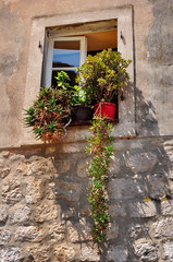 Fototapeta na wymiar Old house and window with pot flowers, Mediterranean scene