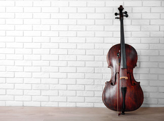 Cello on bricks wall background © Africa Studio