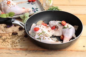 Fresh chicken and tomatoes with spices for cooking