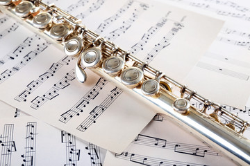 Flute on music notes background