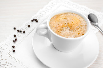 Coffee cup on the white wood table