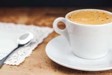 Coffee cup with a spoon on the wood table