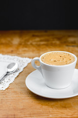Coffee cup on the wood table