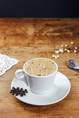 Coffee with a cookie on the wood table