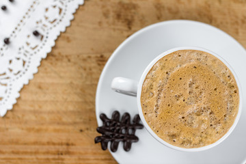 Coffee with a cookie on the wood table