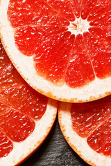 Slices of red grapefruit, top view, selective focus
