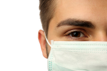 Young male doctor on white background