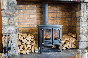 Wood Burning Stove in a Brick Fireplace
