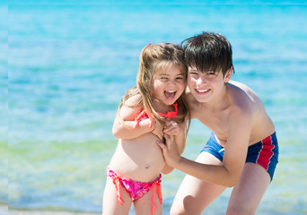 Brother and sister playing at sea