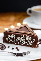 Chocolate Cake with coffee cup in the background 