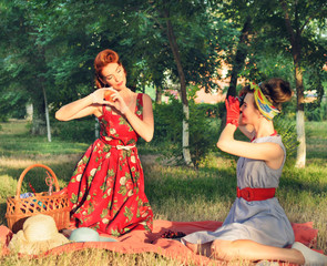 Girls make pictures at a picnic retro