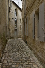 Fototapeta na wymiar Ruelle à gros pavés typique à caractère médiévale au centre historique de Saintes 