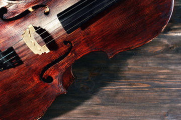 Vintage cello on wooden background