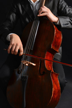 Man playing on cello close up