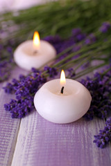 Obraz na płótnie Canvas Candles with lavender flowers on table close up