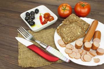 Poultry sausages on a wooden table, preparing home-made snacks. Ingredients for seasoning sausages.
