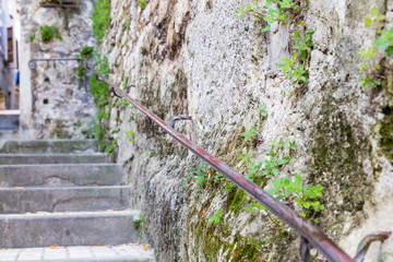 Ancient stone stairs with handrails in the old town