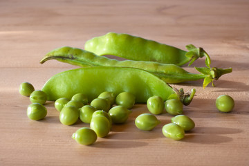 green peas on wooden table