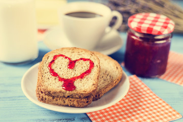 Obraz na płótnie Canvas heart of jam on a toast, with a cross-process effect