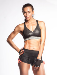 Obraz premium hispanic sportswoman standing on white background in elegance pose