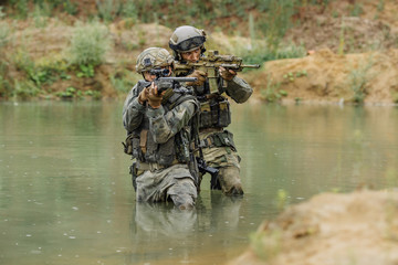 Military team crossing the river under fire