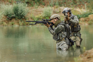 Military team crossing the river under fire