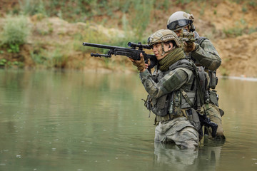 Military team crossing the river under fire