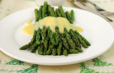 freshly cooked green asparagus with hollandaise sauce