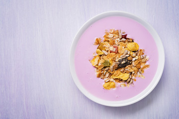 Top view of a plate of muesli with yogurt and space for text