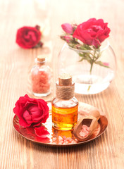 Obraz na płótnie Canvas Rose essential oil, sea salt and rose flowers. Body Care and Spa