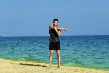 Fototapeta na wymiar Young man sporty doing exercise on beach