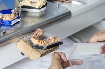 Dental technician working with teeth.