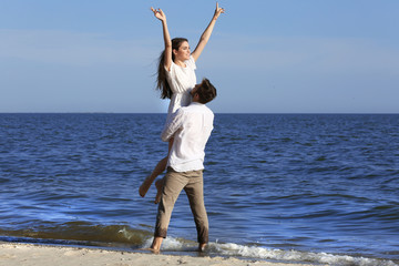 Young couple hugging on beach