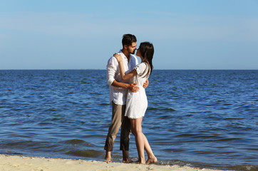 Young couple hugging on beach